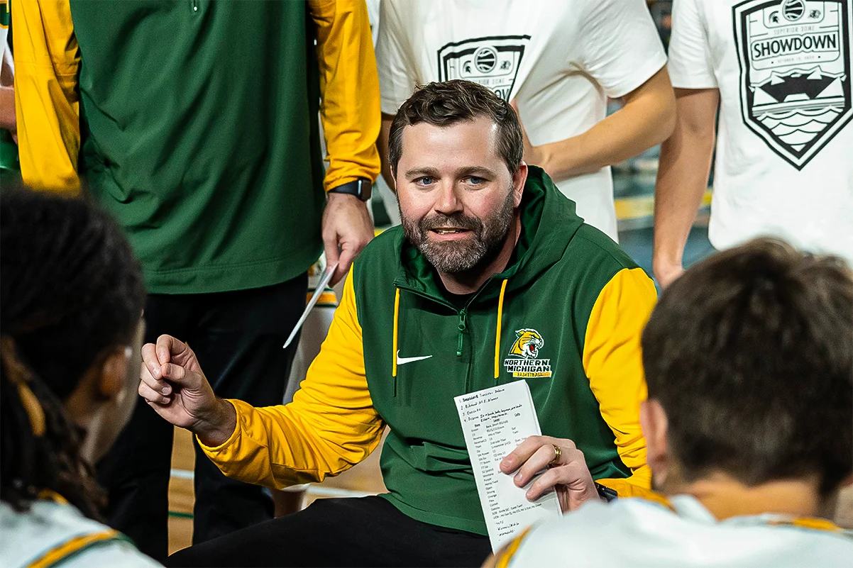 Coach MM in team huddle